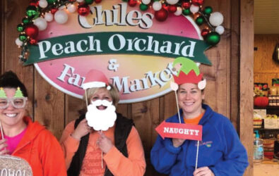 People with Christmas props at Chiles Peach Orchard