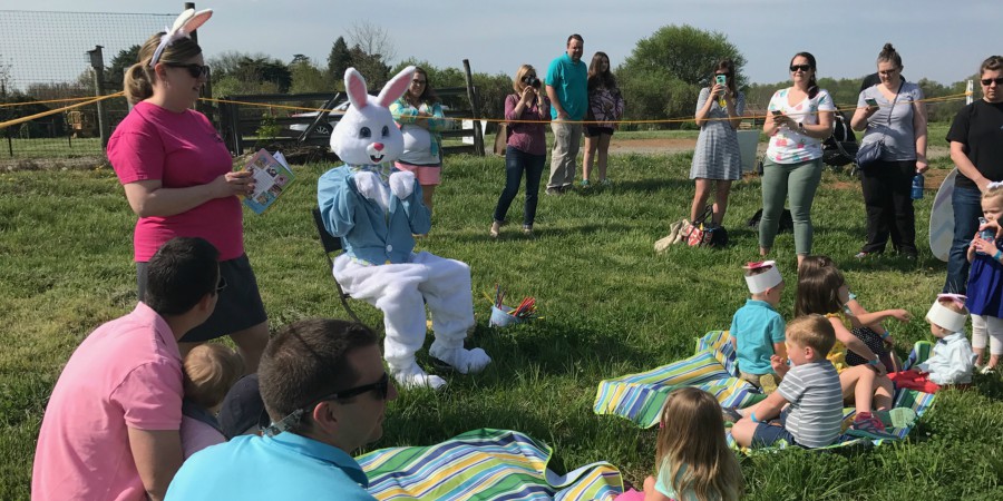 Easter bunny reading to kids at Hop Into Spring event