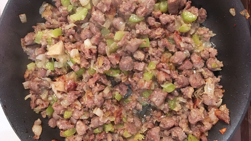 Cooking filling with sauage, celery, broth, and stuffing mix