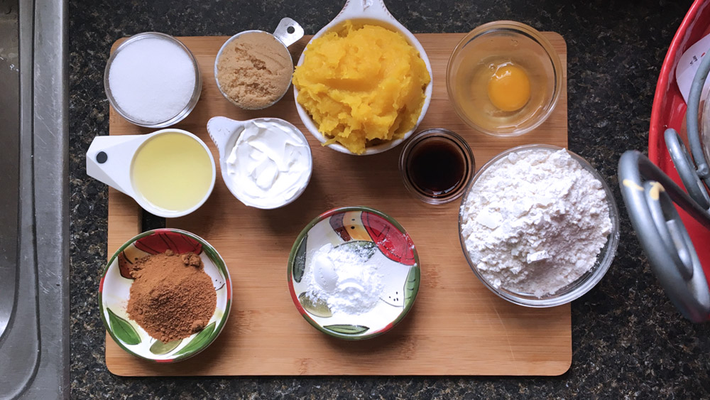 Ingredients for pumpkin bread include white and brown sugar, egg, coconut oil, vanilla extract, sour cream, pumpkin puree, cinnamon, pumpkin pie spice, and ground nutmeg