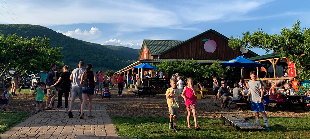 Kids playing cornhole and eating ice cream