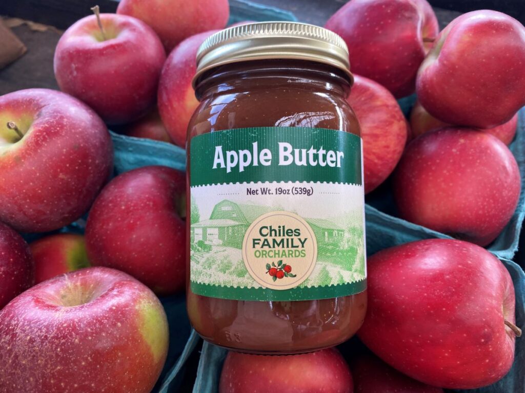 Jar of apple butter with apples
