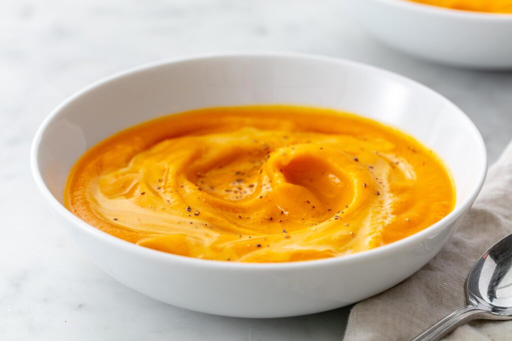 A bowl of creamy pumpkin soup.
