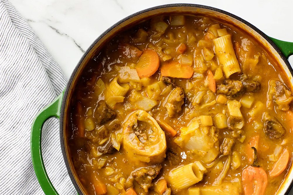 A pot of Haitian beef and pumpkin soup.
