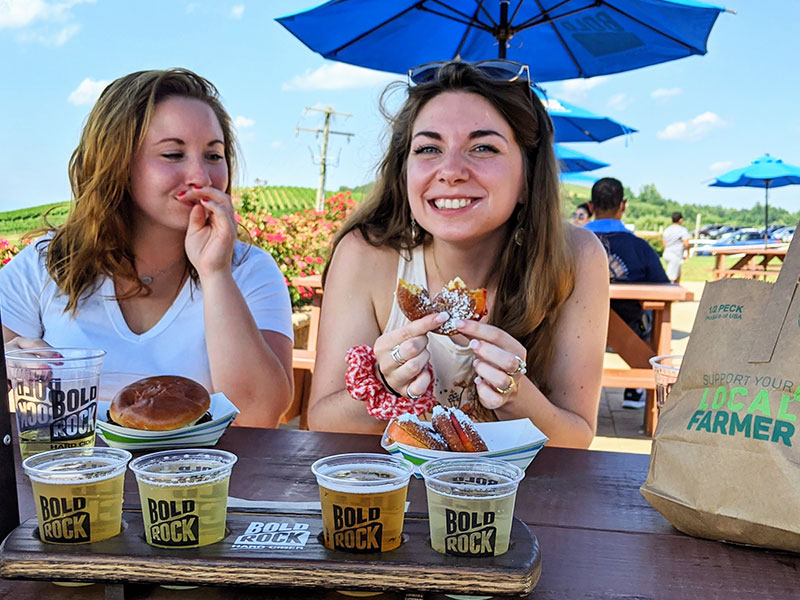 Ladies with flight of Bold Rock Hard Cider and Peach Sliders