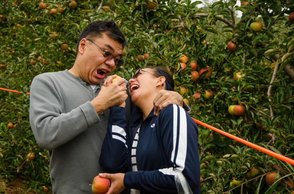 Friends pretending to eat an apple
