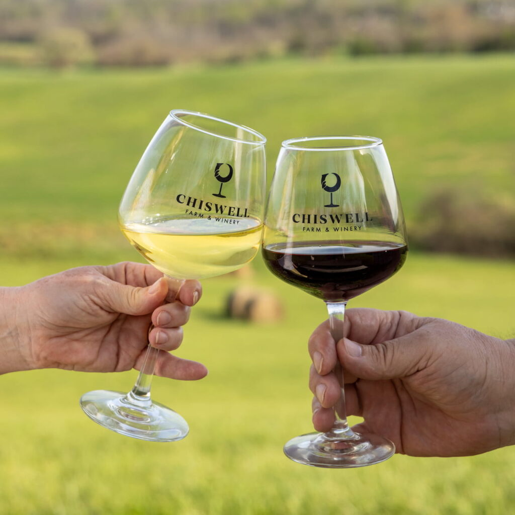 Two people making a toast with Chiswell wine glasses