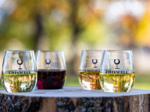 Wine tasting flight - 4 wines placed on an ash oak platter