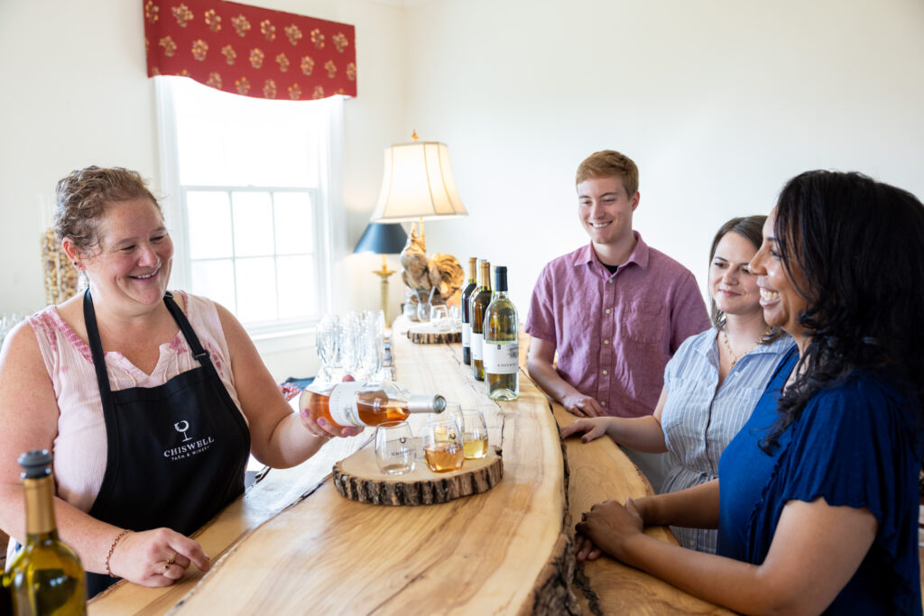 Small group smiling with wine tasting flight