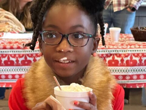 Cookies & Cocoa with Santa. Kid with hot chocolate