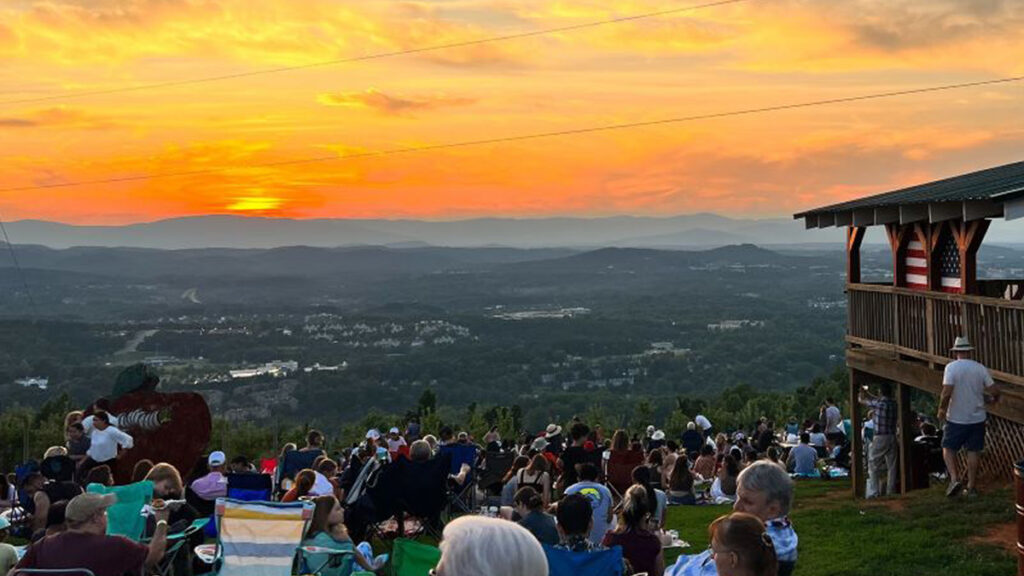 Sunset over Carter Mountain Orchard with American flag decor in the background