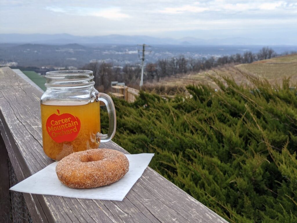 cider donut next to mug of carter mountain orchard cider