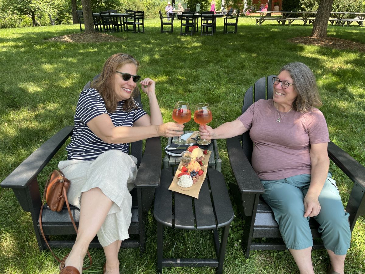 friends sharing a charcuterie board on Chiswell lawn