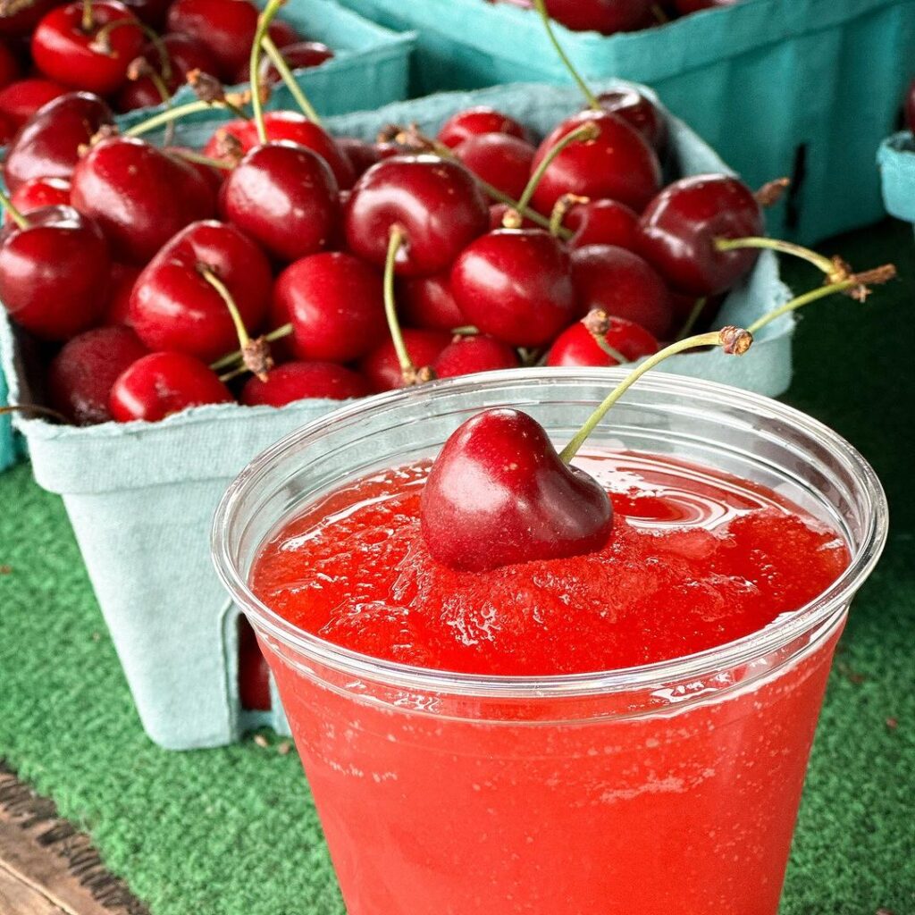 A basket of cherries and a cherry slushie.