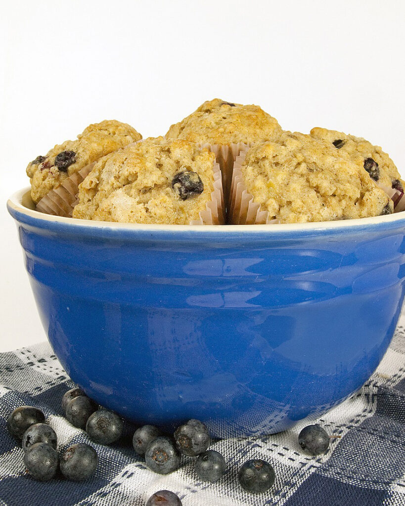 A bowl full of blueberry muffins.