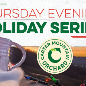 Thursday Evening Holiday Series hosted by Carter Mountain Orchard; photo of branded mug on deck railing with sunset in distance