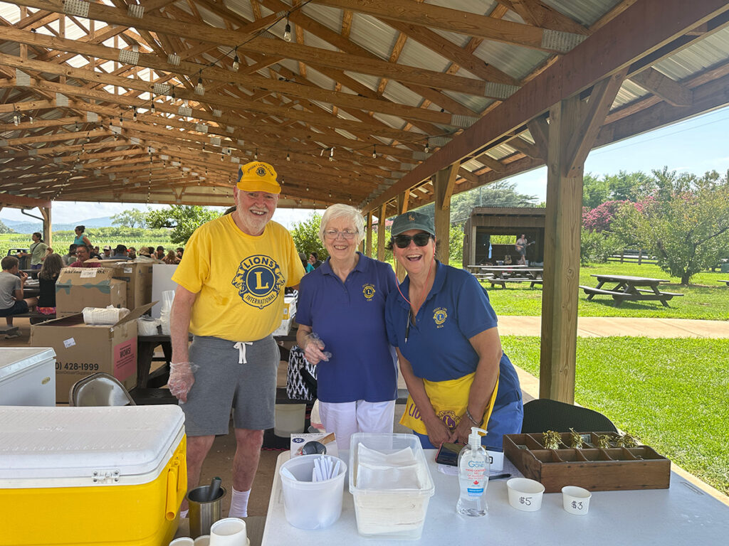 Lions Club members serving peach ice cream at Chiles Peach Orchard