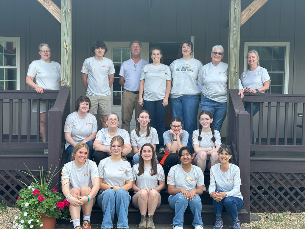 The staff of Chiles Peach Orchard, seated on porch steps