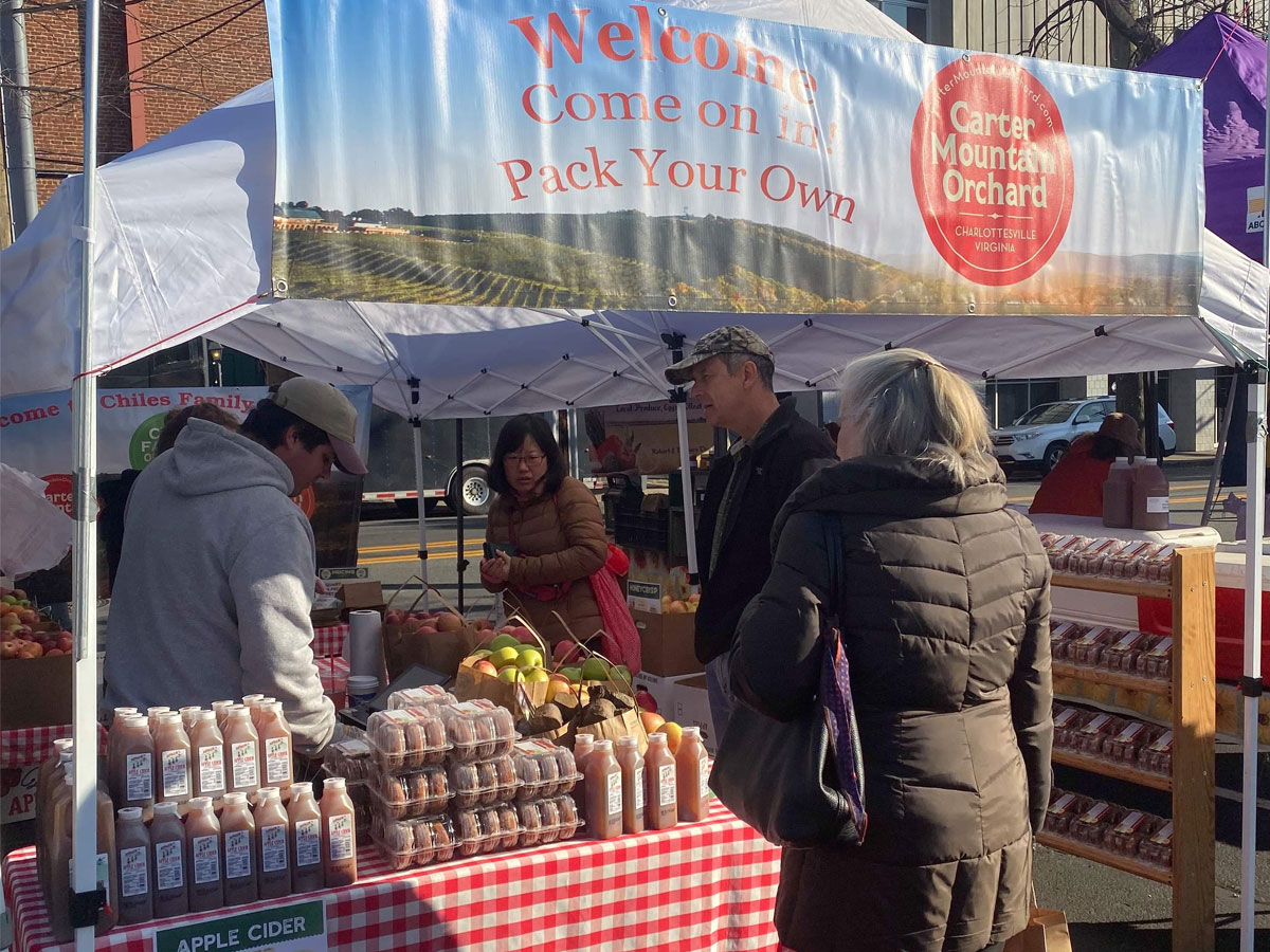 Carter Mountain Orchard stand at City Holiday Market with donuts and apple cider