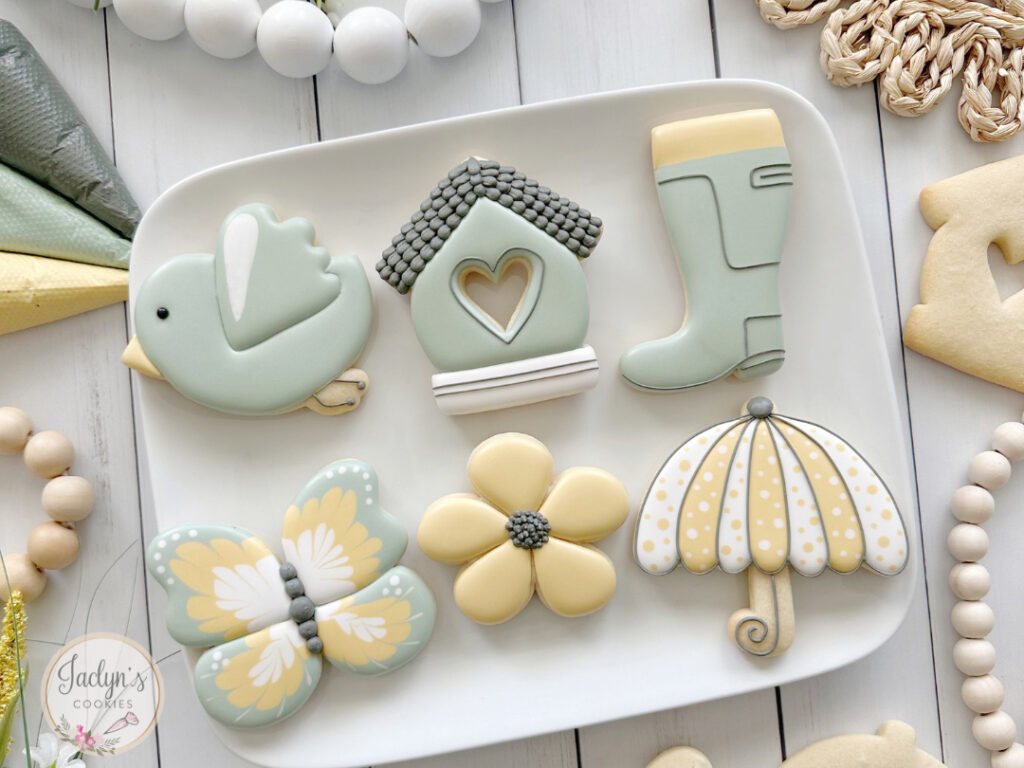 Decorated sugar cookies with a green and yellow spring motif.