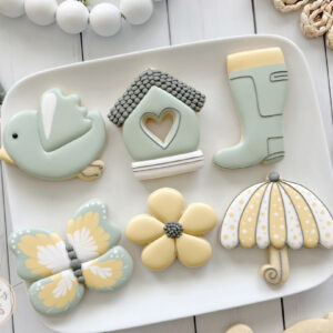 Decorated sugar cookies with a green and yellow spring motif.