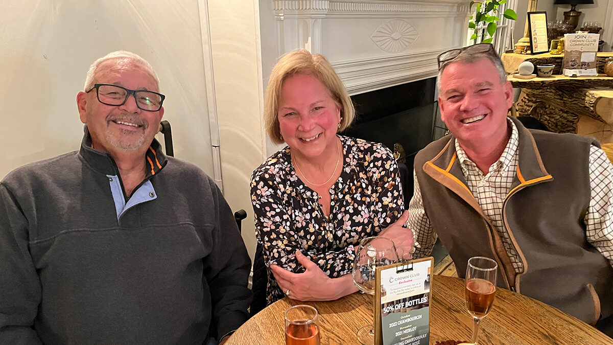 A group of three enjoying wine at Chiswell's Crown Club Members Night