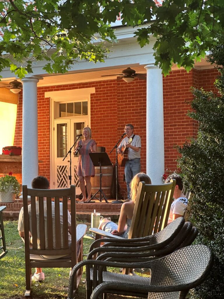 Two musicians on the patio of Chiswell Farm & Winery at sunset