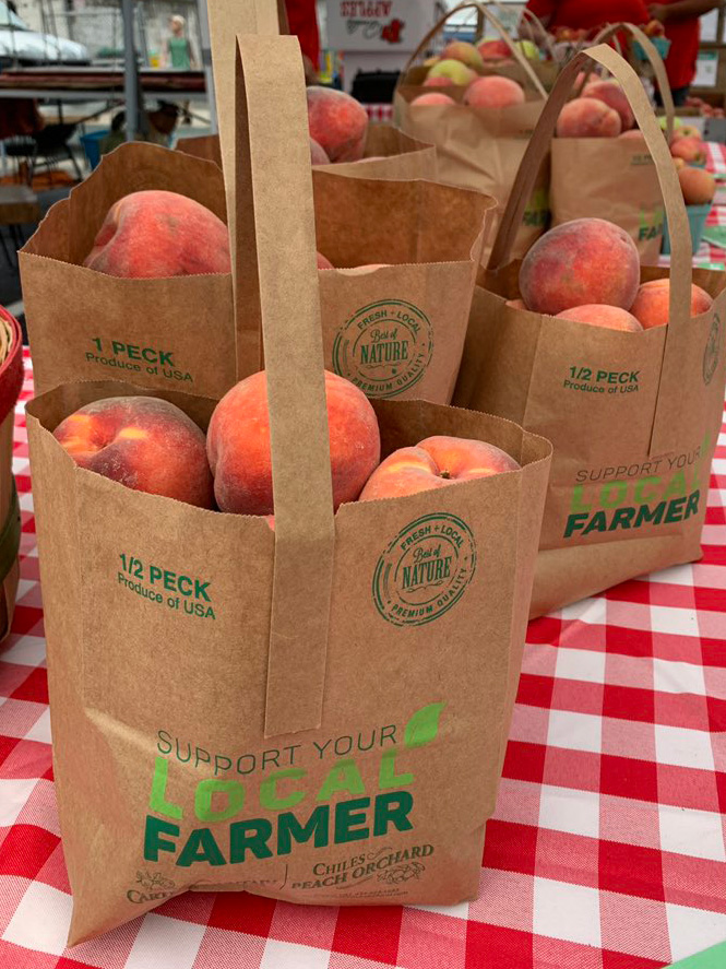 Peaches in paper bags.