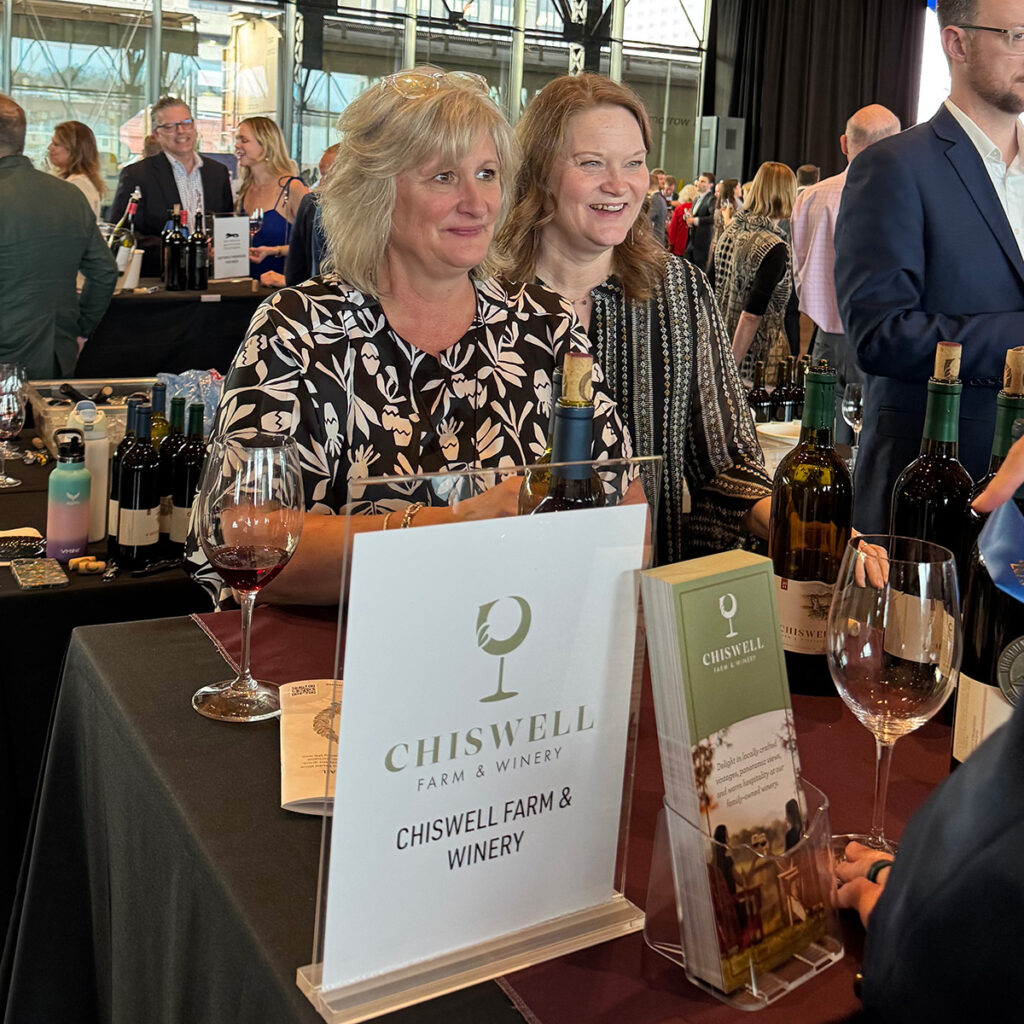 Two women serving wine from the Chiswell table at the Governor's Cup Gala in Richmond