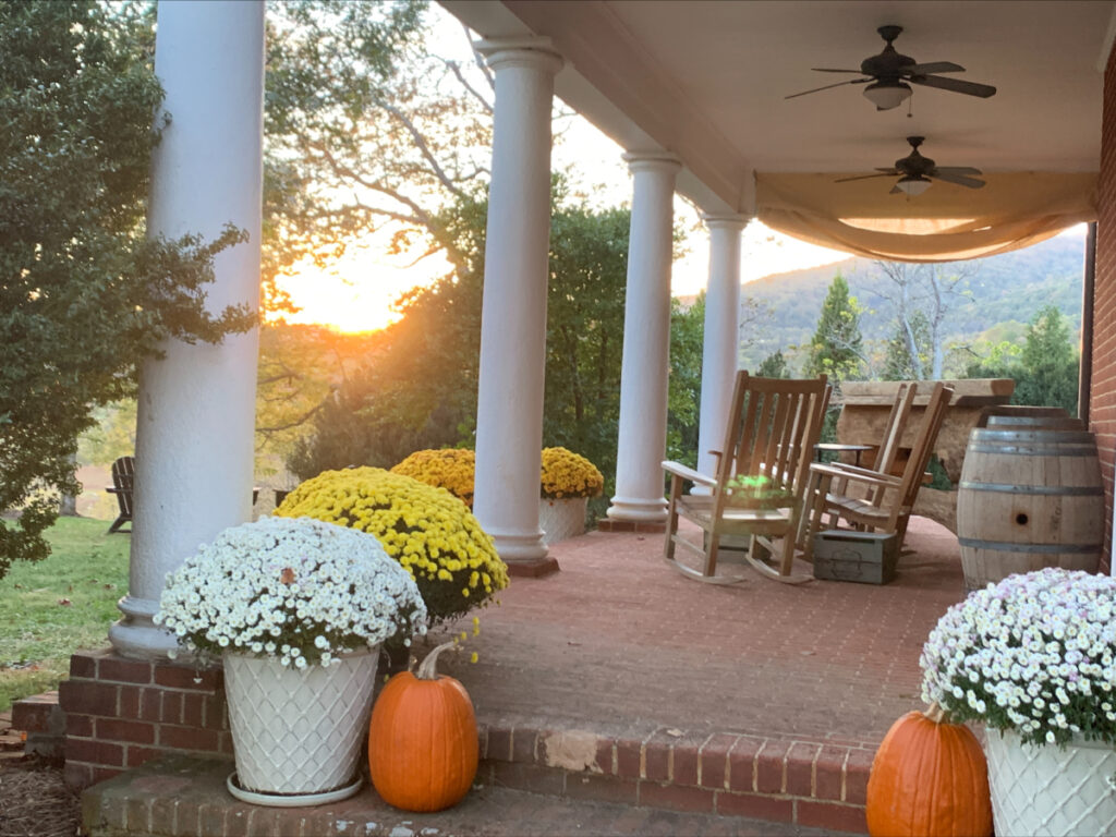 A historic Virginian porch during a fall sunset.