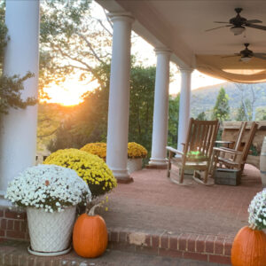 A historic Virginian porch during a fall sunset.