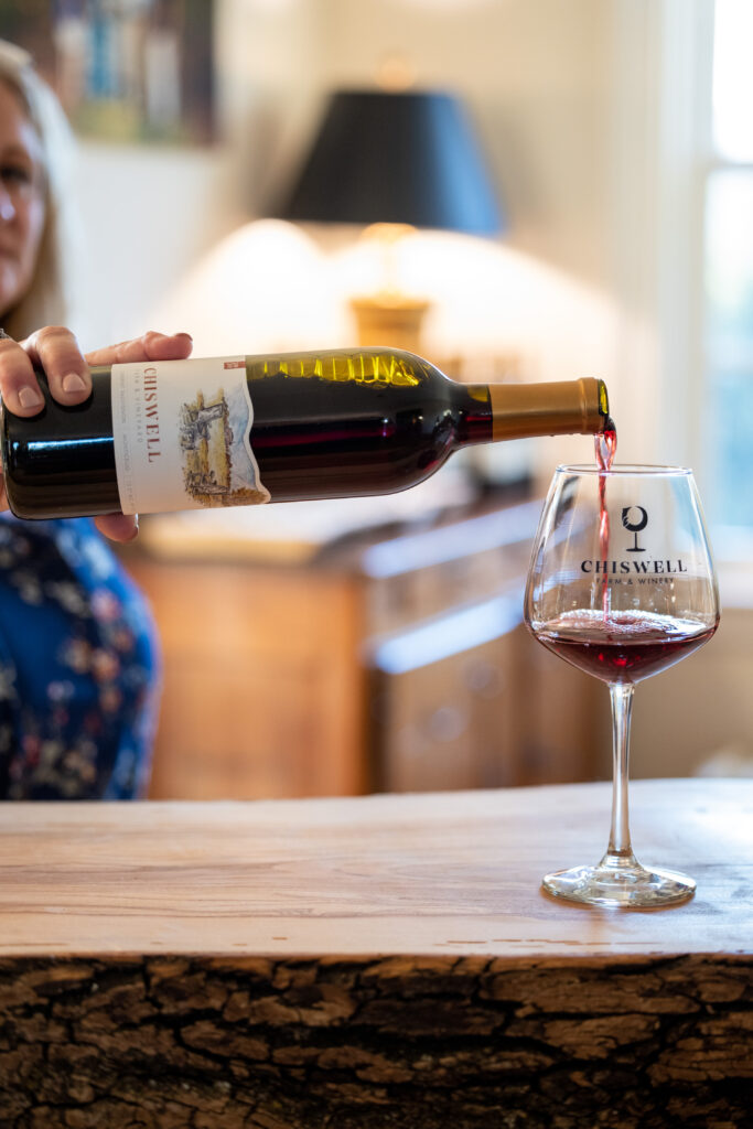 Red wine being poured at a bar