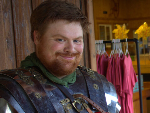 A smiling man in Roman armor