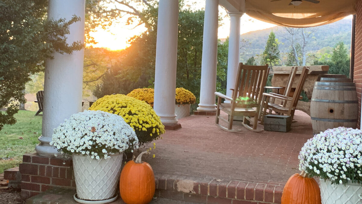 A historic Virginian porch during a fall sunset.