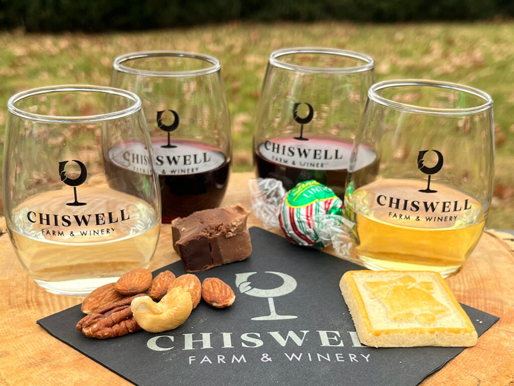 Four wine glasses with small sweet and savory pairings outside.