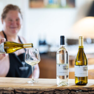 White wine being poured on a wooden bar