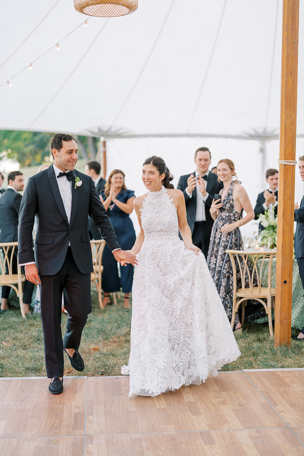 A wedding couple stepping onto an outdoor dance floor