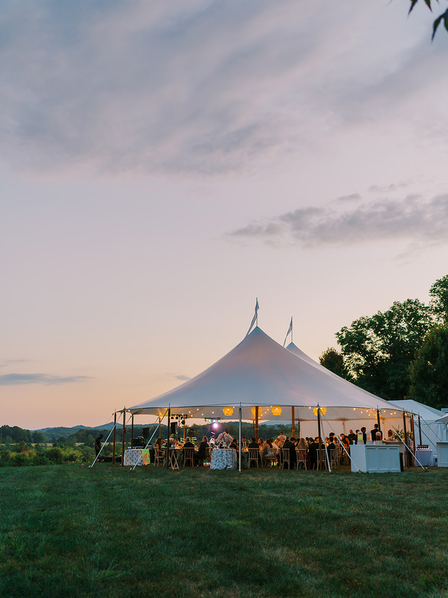 A wedding reception pavilion outdoors at sunset