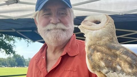 A man holding an owl