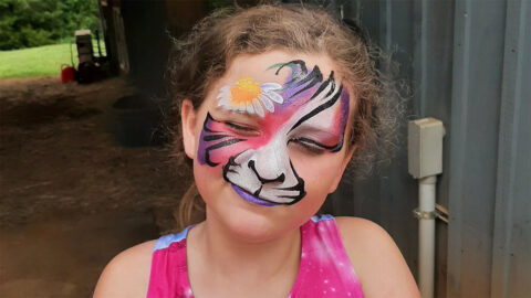 A girl with colorful cat facepaint