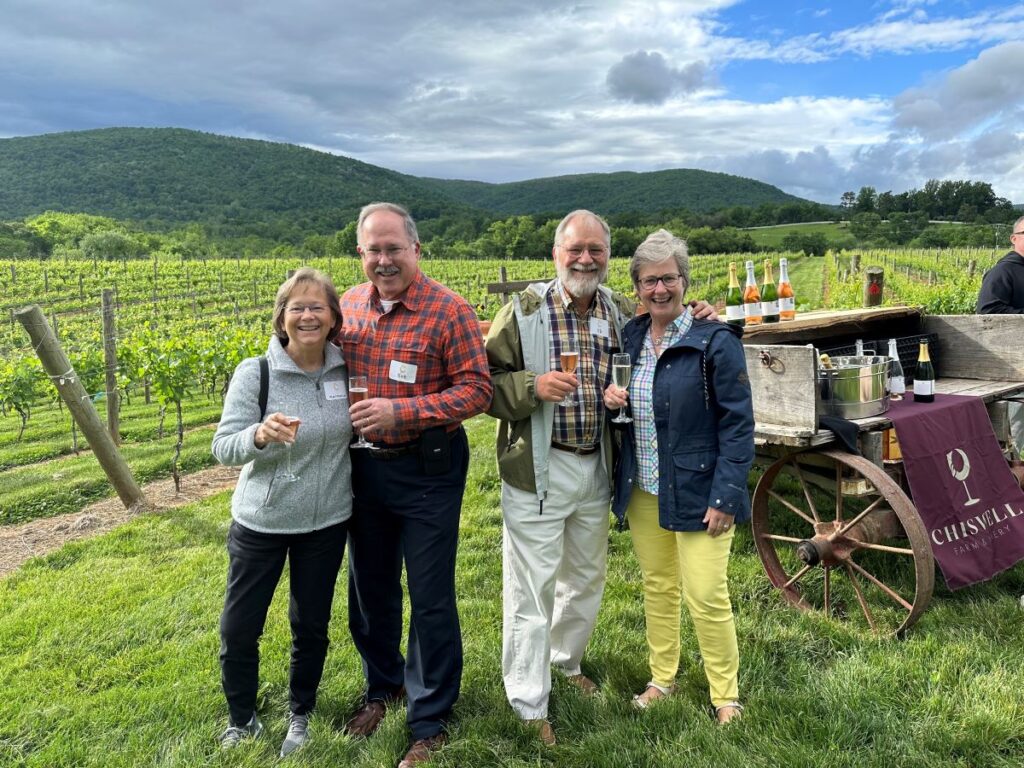 A group of guests with wine in a vineyard