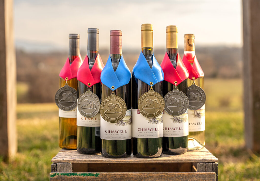 A group of six wines outdoors with award medals