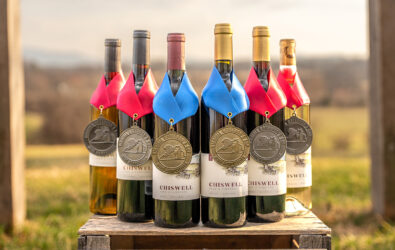A group of six wines outdoors with award medals
