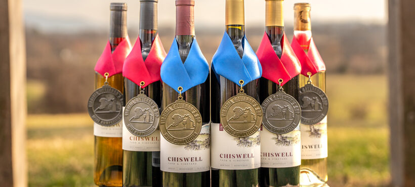 A group of six wines outdoors with award medals