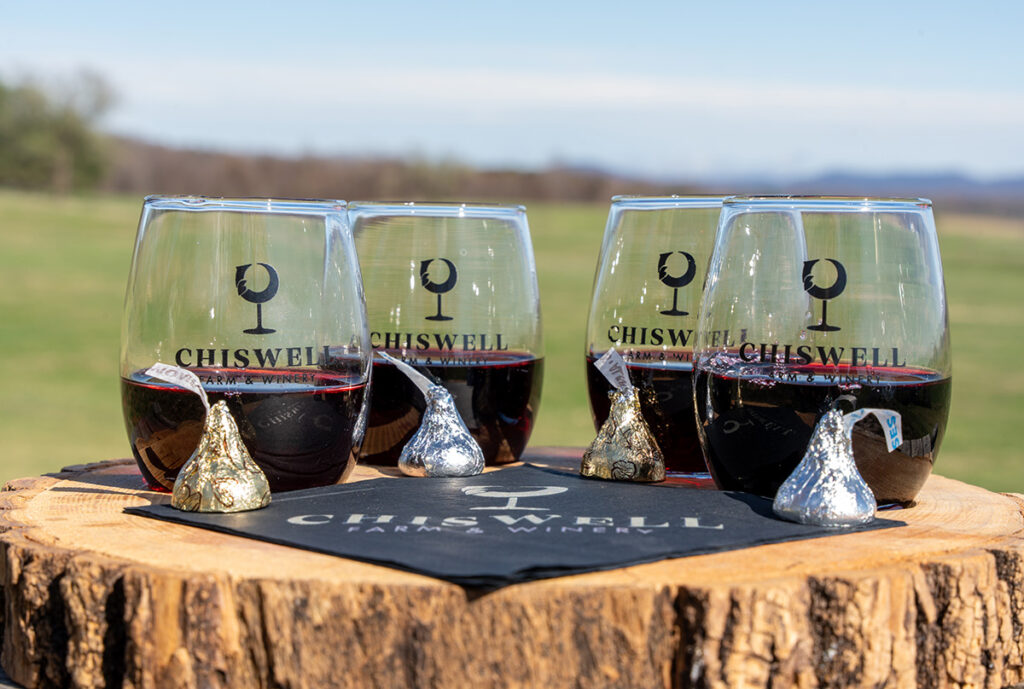 A tasting flight of four red wines with hershey's kisses