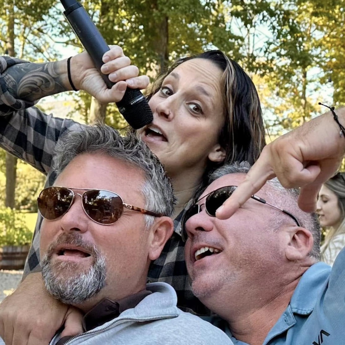 Rachael Karpo singing with two men