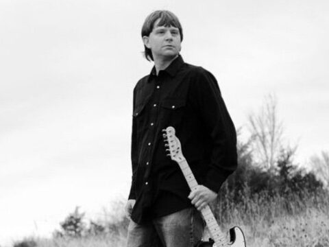 A black-and-white photo of a guitarist