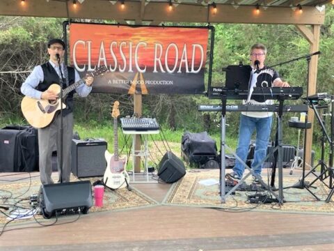 A guitarist and a keyboardist performing outdoors