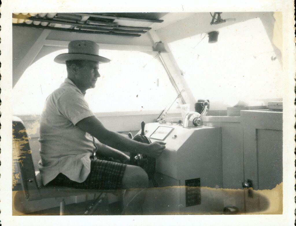 Henry Chiles at the controls of a boat