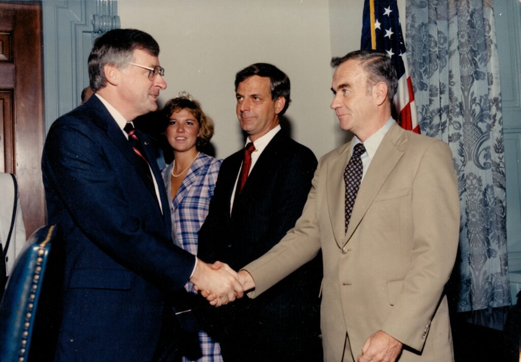 Two men in suits shaking hands